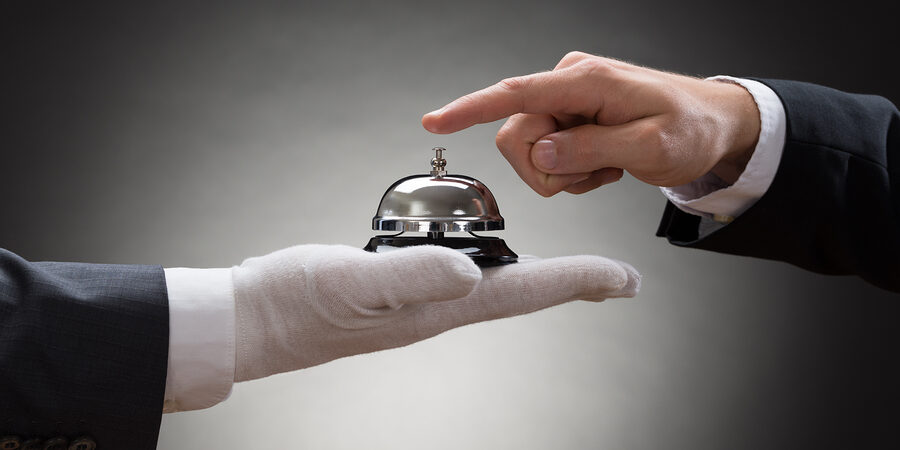 Close-up Of A Person's Hand Ringing Service Bell Close-up Of A Person's Hand Ringing Service Bell Hold By Waiter